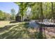 Charming backyard building featuring a screened-in porch and surrounded by mature trees, creating a serene retreat at 605 Faucette Mill Rd, Hillsborough, NC 27278
