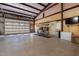 Spacious garage with high ceilings, multiple doors, and ample storage at 605 Faucette Mill Rd, Hillsborough, NC 27278
