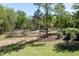 Lush garden area with mulch paths, framed by green trees and shrubs at 605 Faucette Mill Rd, Hillsborough, NC 27278