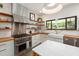 Modern kitchen featuring butcher block counters, open shelves, stainless steel appliances, and a farmhouse sink at 605 Faucette Mill Rd, Hillsborough, NC 27278