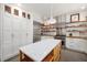 Bright kitchen with stainless steel appliances, butcher block countertops, and marble-topped island at 605 Faucette Mill Rd, Hillsborough, NC 27278