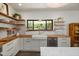 Kitchen featuring butcher block counters, open shelves, stainless steel appliances, and a farmhouse sink at 605 Faucette Mill Rd, Hillsborough, NC 27278