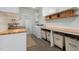 Bright laundry room with butcher block countertops and plenty of storage at 605 Faucette Mill Rd, Hillsborough, NC 27278