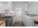 Well-equipped laundry room with butcher block countertops, sink, washer, and dryer at 605 Faucette Mill Rd, Hillsborough, NC 27278