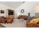 Cozy living room featuring leather furniture, neutral rug, and wooden entertainment center at 605 Faucette Mill Rd, Hillsborough, NC 27278