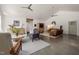 Spacious living room with hardwood floors, ample seating, and lots of natural light at 605 Faucette Mill Rd, Hillsborough, NC 27278