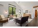 Bright living area with large windows, stylish seating, and natural light, creating an inviting atmosphere at 605 Faucette Mill Rd, Hillsborough, NC 27278