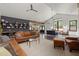 Open concept living room boasts vaulted ceilings, built-in bookshelves, and seamlessly connects to the dining area at 605 Faucette Mill Rd, Hillsborough, NC 27278