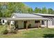 Relaxing covered front porch with comfortable seating and a charming porch swing at 605 Faucette Mill Rd, Hillsborough, NC 27278