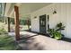 Comfortable covered front porch with plants and a view of the lawn at 605 Faucette Mill Rd, Hillsborough, NC 27278