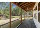 Inviting screened porch featuring a ceiling fan and a view of the lush backyard, ideal for enjoying the outdoors at 605 Faucette Mill Rd, Hillsborough, NC 27278
