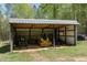 Open shed, ideal for storing equipment or tools with ample room for parking at 605 Faucette Mill Rd, Hillsborough, NC 27278