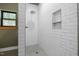 Bright shower features white subway tile, a built-in niche, and a rain shower head at 605 Faucette Mill Rd, Hillsborough, NC 27278