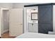 Bedroom view to ensuite bathroom featuring modern barn door entry, vanity and mirror at 608 Derby Ct, Durham, NC 27707