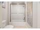 Bathroom featuring a shower with a sliding glass door and white tile surround at 608 Derby Ct, Durham, NC 27707