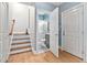 Hallway view of bathroom featuring a walk-in shower, gray vanity, and patterned rug at 608 Derby Ct, Durham, NC 27707