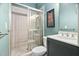 Updated bathroom with tiled walk-in shower, vanity, and soft green walls at 608 Derby Ct, Durham, NC 27707