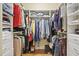 Walk-in closet with custom shelving, hanging rods, and hardwood floors at 608 Derby Ct, Durham, NC 27707