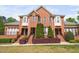 Charming two-story brick home featuring a well-manicured lawn and appealing front entryway at 608 Derby Ct, Durham, NC 27707