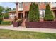 Attractive brick townhouse with manicured hedges, wrought iron railings, and a welcoming entrance at 608 Derby Ct, Durham, NC 27707