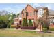 Charming brick townhouse with a landscaped front yard and flowering tree, offering inviting curb appeal at 608 Derby Ct, Durham, NC 27707