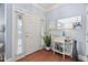 Bright foyer featuring hardwood floors, elegant console table, and decorative mirror at 608 Derby Ct, Durham, NC 27707