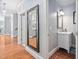 Hallway with wood floors and a decorative mirror at 608 Derby Ct, Durham, NC 27707