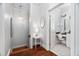 Hallway with crystal chandelier leading to a bathroom with vanity at 608 Derby Ct, Durham, NC 27707