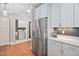 Spacious kitchen with stainless steel refrigerator and convenient access to the laundry room at 608 Derby Ct, Durham, NC 27707