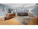 Spacious living room featuring desk, sofa, rug, and light blue walls at 608 Derby Ct, Durham, NC 27707