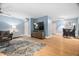 Spacious living room featuring wood flooring, sofa, bar seating, and large TV at 608 Derby Ct, Durham, NC 27707