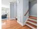 Living room with hardwood floors, stairs, and access to outdoor light at 608 Derby Ct, Durham, NC 27707