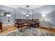 Cozy living room featuring a large sofa, wood floors and rug at 608 Derby Ct, Durham, NC 27707