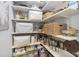 Organized pantry with shelving and storage baskets, providing ample space for groceries and supplies at 608 Derby Ct, Durham, NC 27707