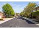 Residential street lined with brick townhouses and lush trees, creating a welcoming neighborhood atmosphere at 608 Derby Ct, Durham, NC 27707