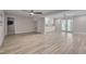 Spacious finished basement area featuring a stylish bar, door to the yard and modern flooring at 6105 Bellow St, Raleigh, NC 27609