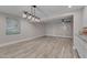 Spacious basement area featuring stylish lighting, wood-look floors, and neutral decor at 6105 Bellow St, Raleigh, NC 27609