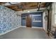 Basement with painted walls, concrete floor, blue accent wall and exposed piping at 6105 Bellow St, Raleigh, NC 27609