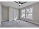 Cozy bedroom with large windows, plush carpet, and a ceiling fan, plus a closet for storage at 6105 Bellow St, Raleigh, NC 27609