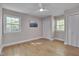 A bright bedroom features hardwood floors, a ceiling fan, and ample closet space at 6105 Bellow St, Raleigh, NC 27609