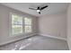 Inviting bedroom filled with natural light from large windows and featuring a modern ceiling fan at 6105 Bellow St, Raleigh, NC 27609