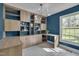 Chic home office with built-in shelving, ample natural light, and a modern light fixture at 6105 Bellow St, Raleigh, NC 27609