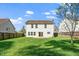 Large fenced backyard with a lawn and patio at 617 Conover Rd, Durham, NC 27703