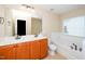 Bathroom with double sinks, tub, and window at 617 Conover Rd, Durham, NC 27703