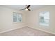 This bedroom features neutral carpet and paint and windows for ample light at 617 Conover Rd, Durham, NC 27703