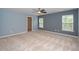 Spacious bedroom with a walk-in closet, natural light, and neutral carpet at 617 Conover Rd, Durham, NC 27703