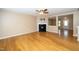Cozy living room with a sleek black fireplace, hardwood floors, and neutral wall color at 617 Conover Rd, Durham, NC 27703
