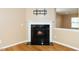 Close-up of a modern fireplace with a decorative mantle and hardwood floors in a cozy room at 617 Conover Rd, Durham, NC 27703