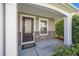Inviting front porch with stone accents, a stylish front door, and a cozy welcome mat at 617 Conover Rd, Durham, NC 27703