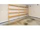 Unfinished garage with wood shelving for storage at 617 Conover Rd, Durham, NC 27703